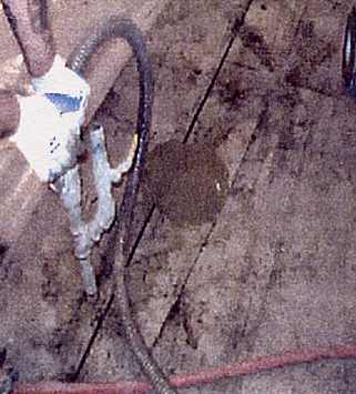 Grout being pumped into one hole and emerging out of next down line hole, on opposite side of joint.